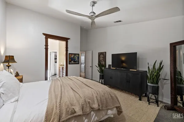 a living room with furniture a large window and wooden floor