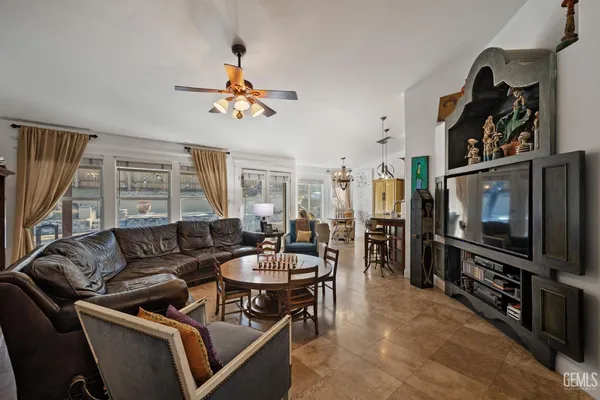 a view of a backyard with wooden fence and a large tree
