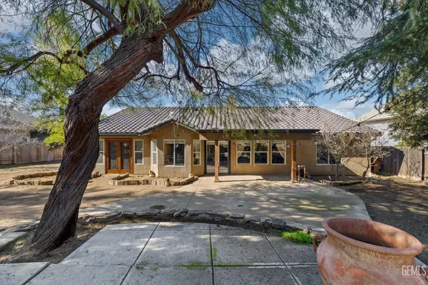 a living room with furniture a flat screen tv and a floor to ceiling window