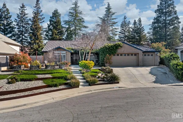 a front view of a house with a yard and outdoor seating
