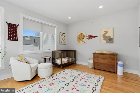 a bedroom with furniture and a wooden floor