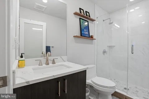 a bathroom with a sink toilet and shower