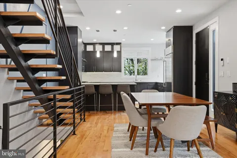 a view of a dining room with furniture and wooden floor