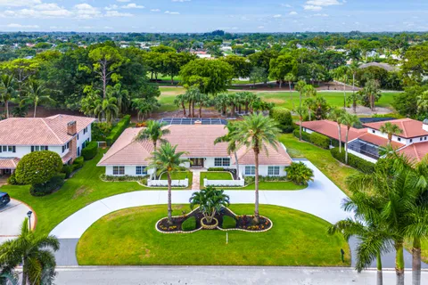 an aerial view of residential houses with outdoor space and swimming pool