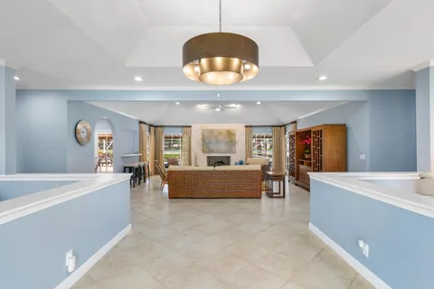 a dining room with furniture a window and a chandelier