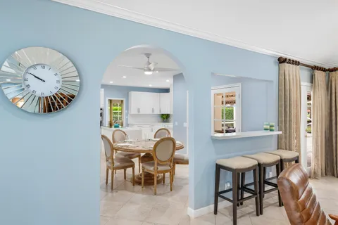 a kitchen with white cabinets and refrigerator