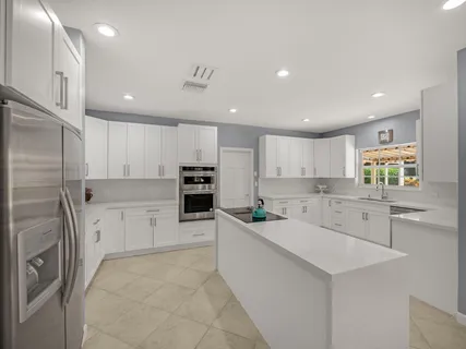 a large bedroom with a large bed and a large window