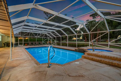 an aerial view of house with yard swimming pool and outdoor seating