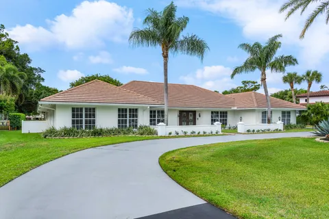 a view of a house with backyard sitting area and garden