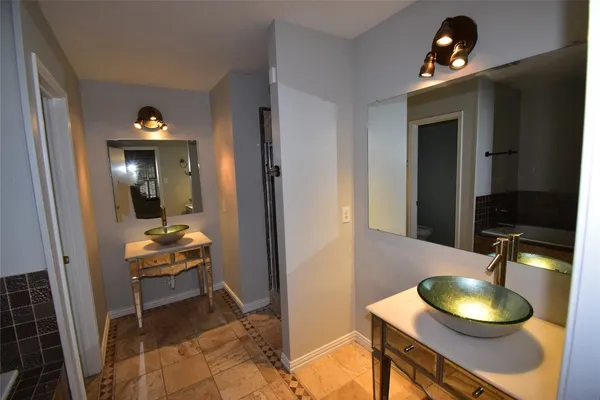 a bathroom with a tub a sink and a shower