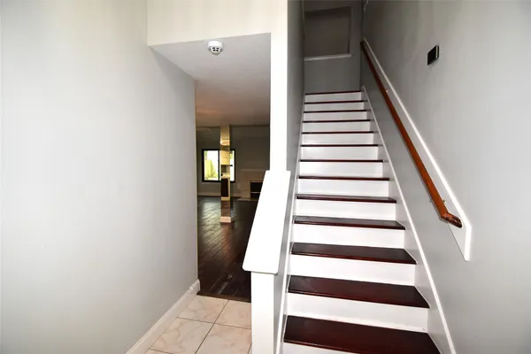 a view of entryway and hall with wooden floor