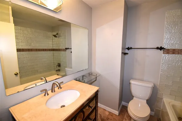 a bathroom with a bathtub and toilet