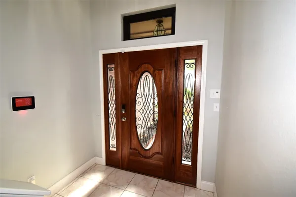 a kitchen with kitchen island granite countertop a refrigerator a sink dishwasher and wooden cabinets with wooden floor