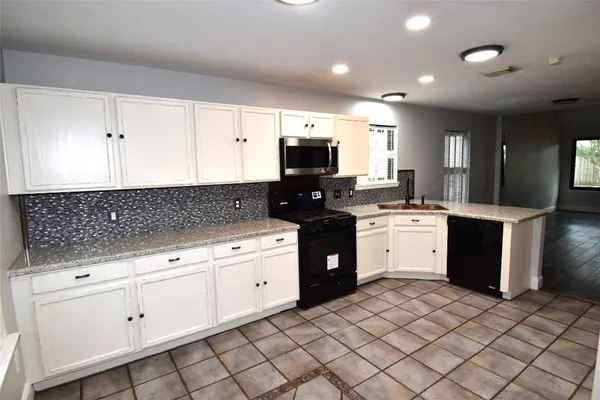 a kitchen with a sink and cabinets