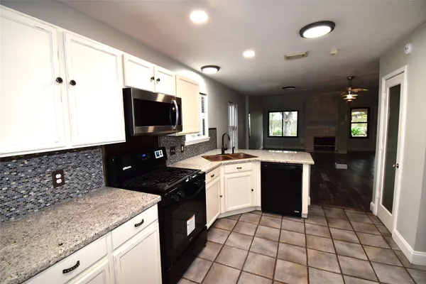 a kitchen with a sink and cabinets