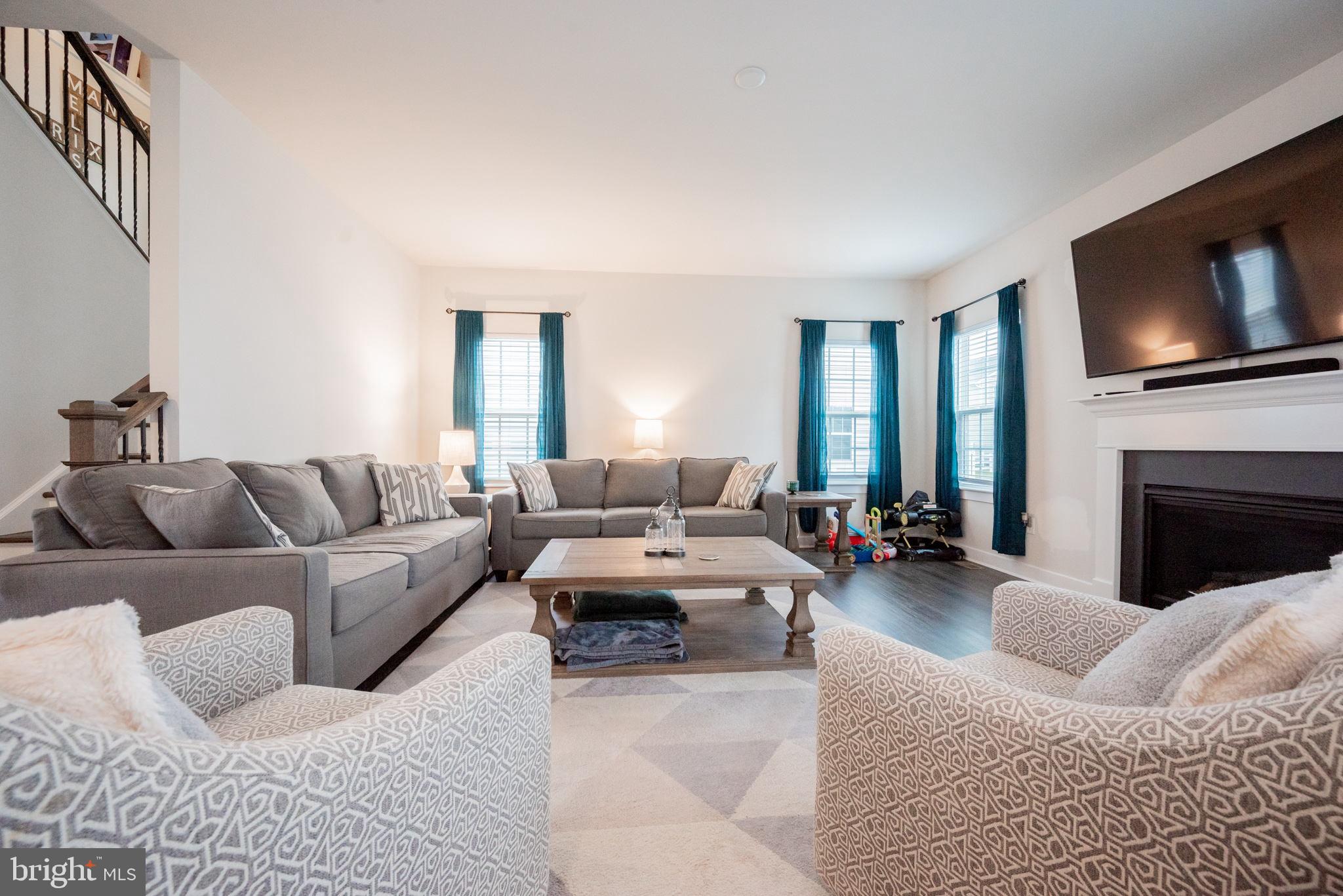 772 Wallasey Drive Middletown, DE 19709 - Photo 13 of 60 a living room with furniture or fireplace and a flat screen tv