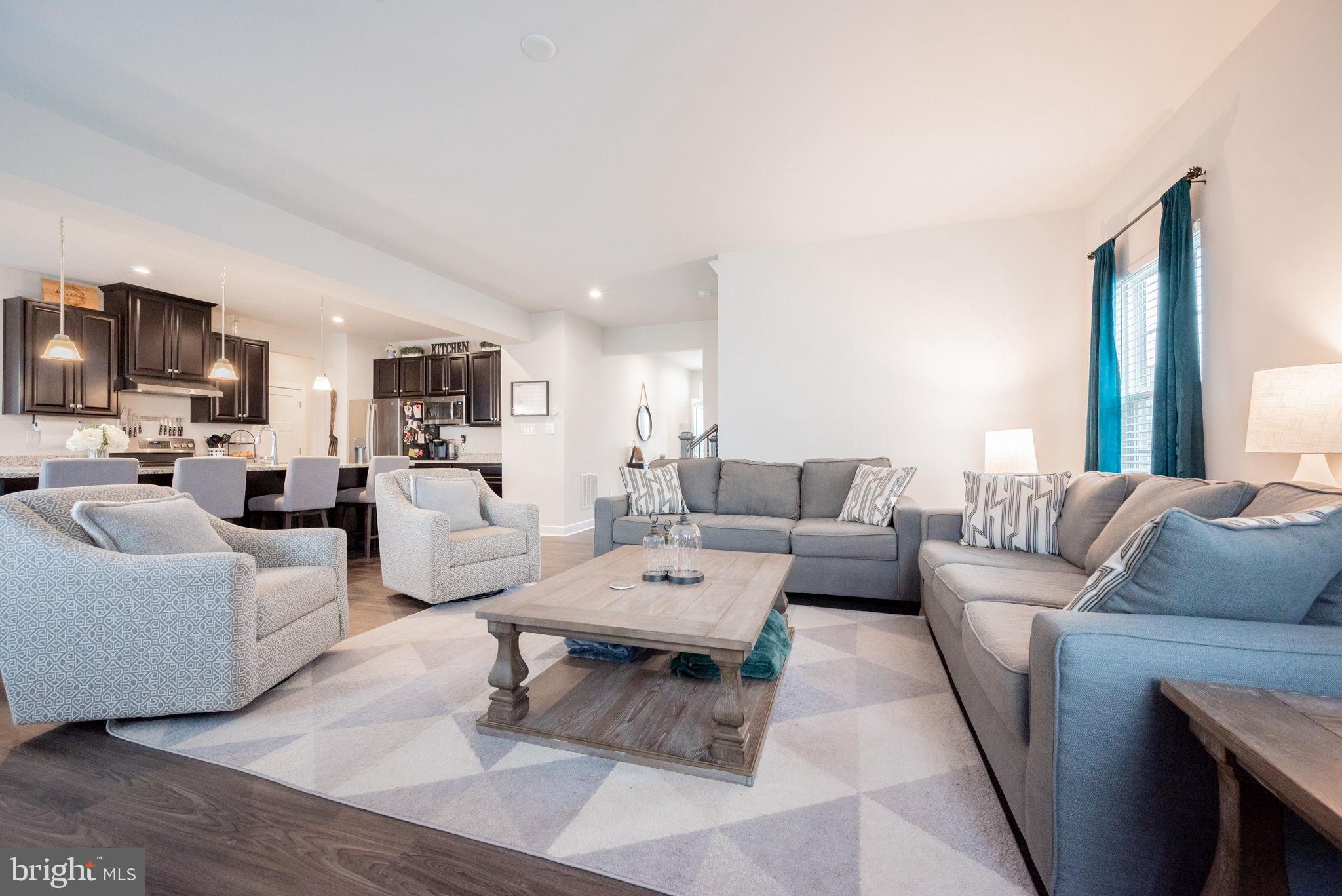 772 Wallasey Drive Middletown, DE 19709 - Photo 16 of 60 a living room with furniture a flat screen tv and a table