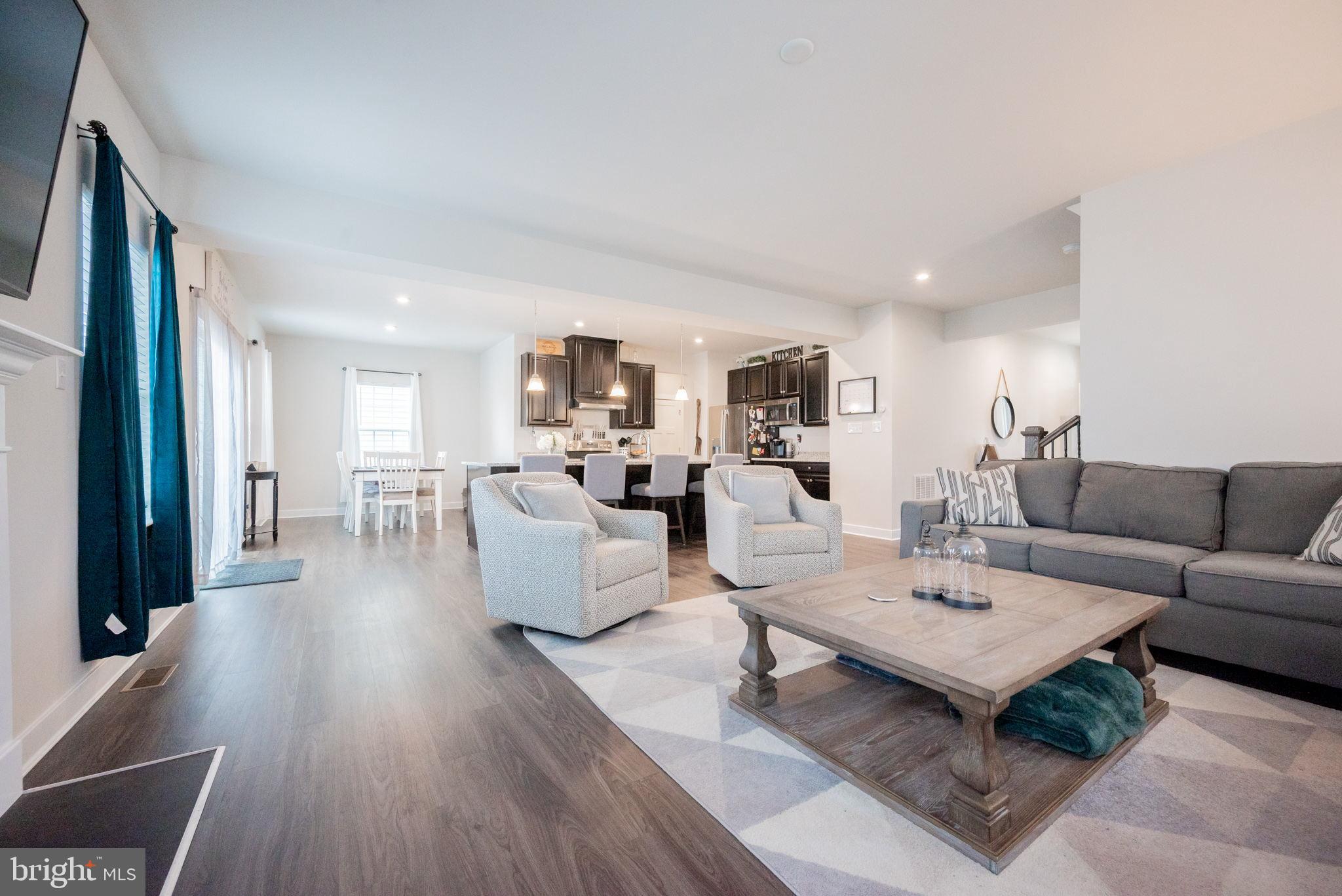 772 Wallasey Drive Middletown, DE 19709 - Photo 17 of 60 a living room with furniture dining table a lamp and a window