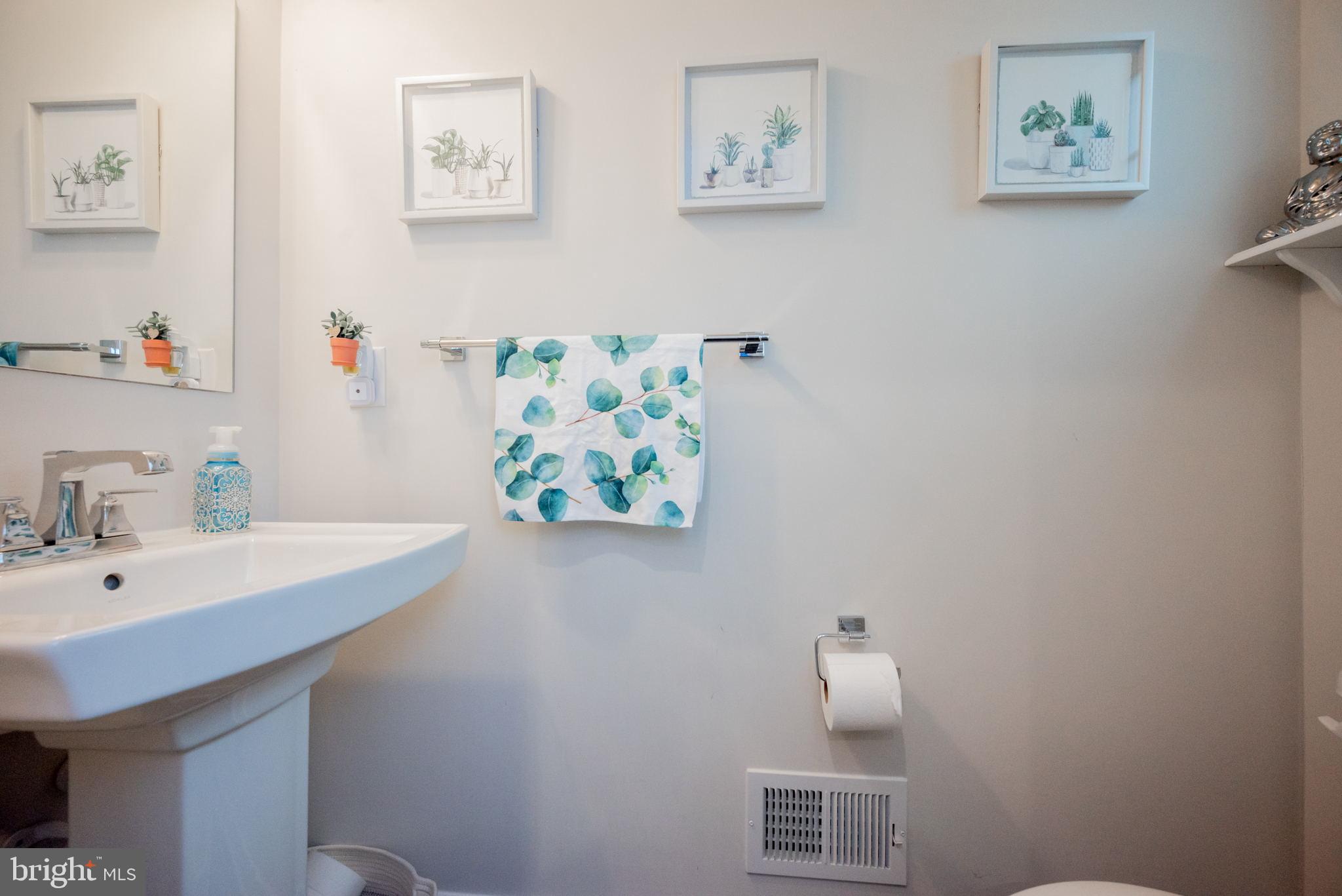 772 Wallasey Drive Middletown, DE 19709 - Photo 26 of 60 a bathroom with a sink a mirror and painting on the wall