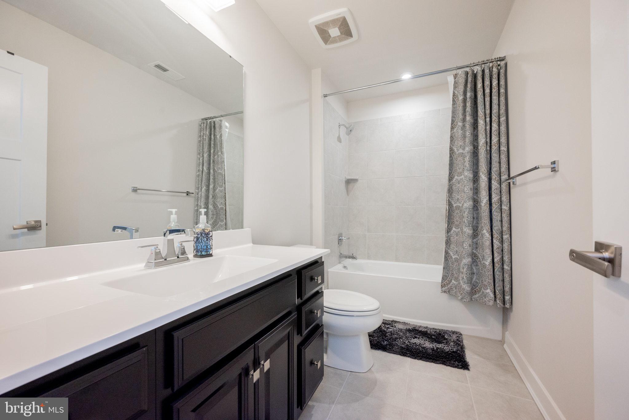 772 Wallasey Drive Middletown, DE 19709 - Photo 30 of 60 a bathroom with a sink a toilet a mirror and shower