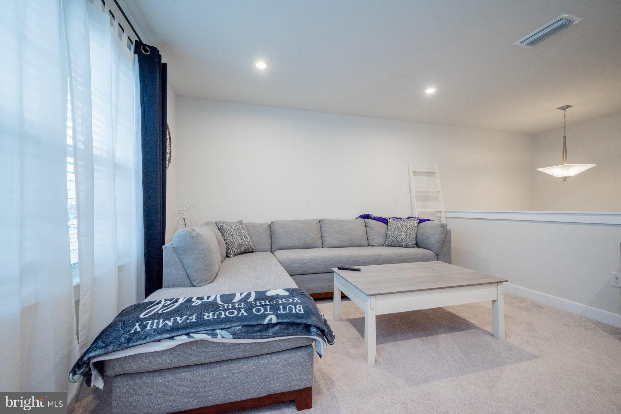 772 Wallasey Drive Middletown, DE 19709 - Photo 41 of 60 a living room with furniture and a chandelier