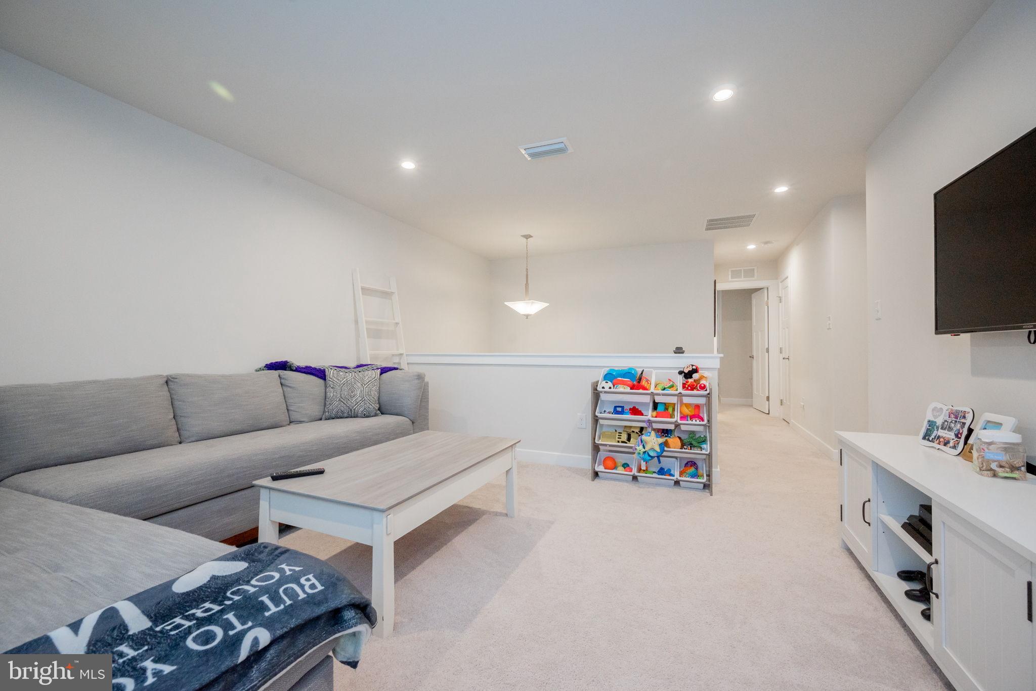 772 Wallasey Drive Middletown, DE 19709 - Photo 42 of 60 a living room with furniture and a flat screen tv