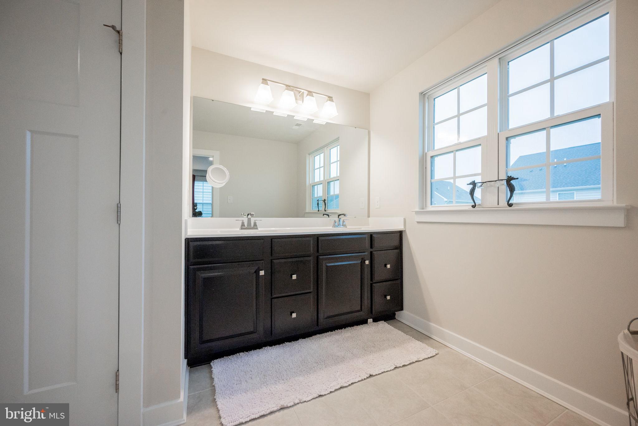 772 Wallasey Drive Middletown, DE 19709 - Photo 54 of 60 a spacious bathroom with a double vanity and a mirror