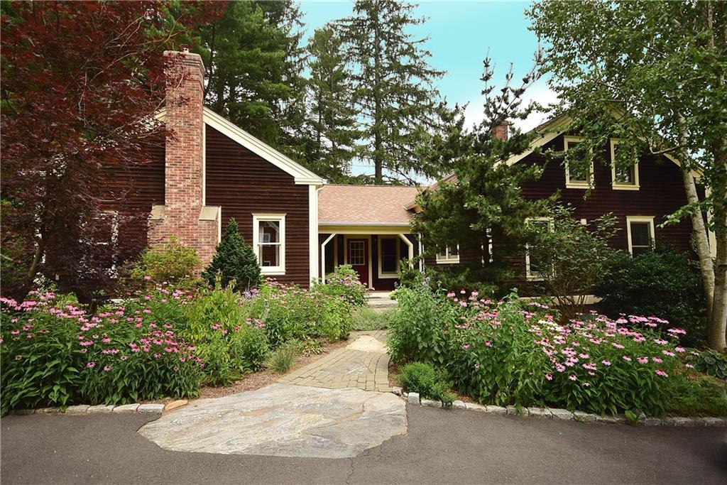 895 Tolland Stage Road Tolland, CT 06084 - Photo 1 of 1 a front view of a house with a garden