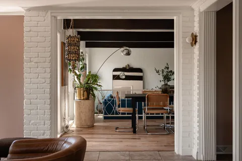 a living room with furniture and a potted plant