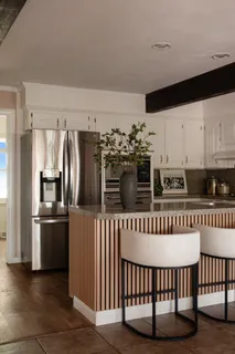 a kitchen with stainless steel appliances a refrigerator and a stove top oven