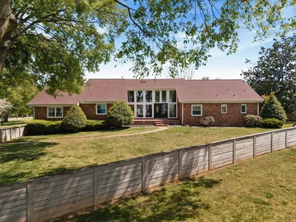 a front view of a house with a yard table and chairs