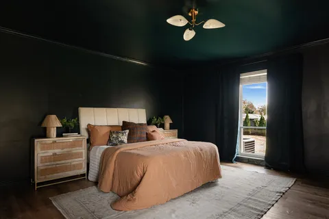 a bedroom with a bed and a large window