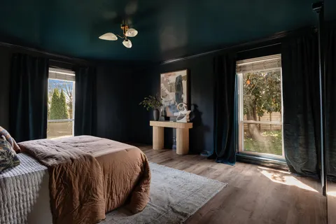 a bedroom with a bed and wooden floor