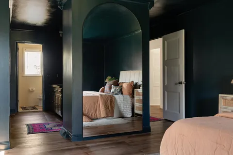 a bathroom with a granite countertop sink and mirror
