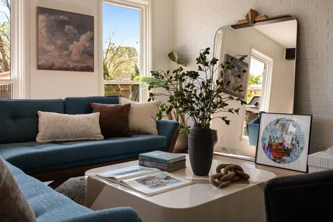 a living room with furniture flowerpot and a window