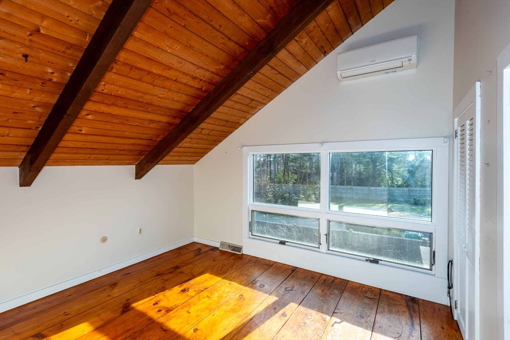 17 Chapman Lane Edgartown, MA 02539 - Photo 18 of 26 a view of a room with wooden floor and a bed