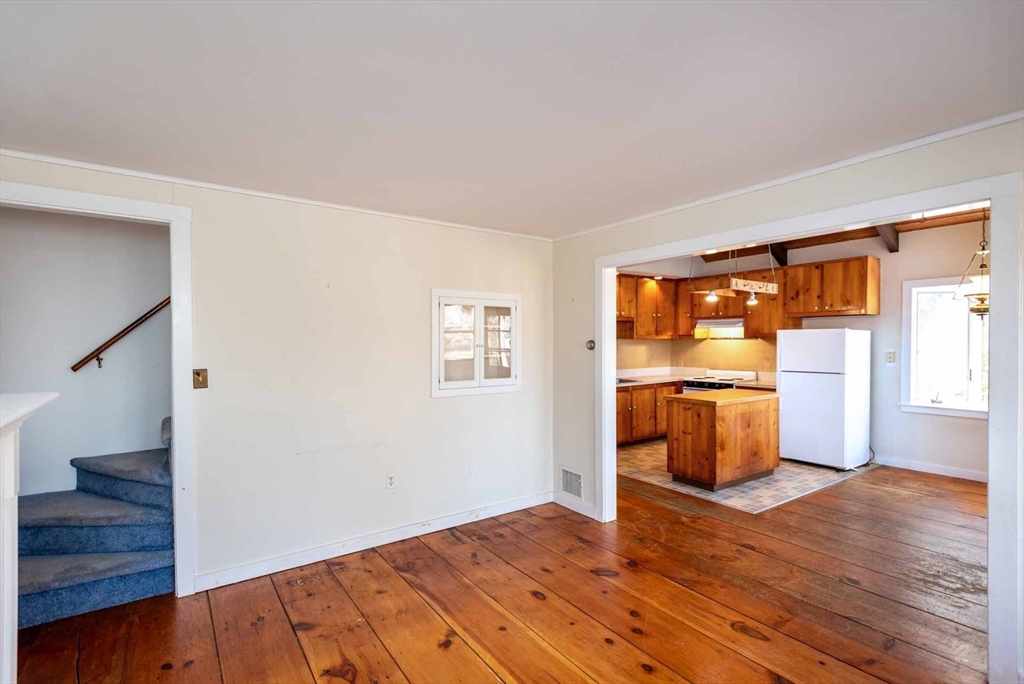 17 Chapman Lane Edgartown, MA 02539 - Photo 7 of 26 a view of empty room with wooden floor and fan
