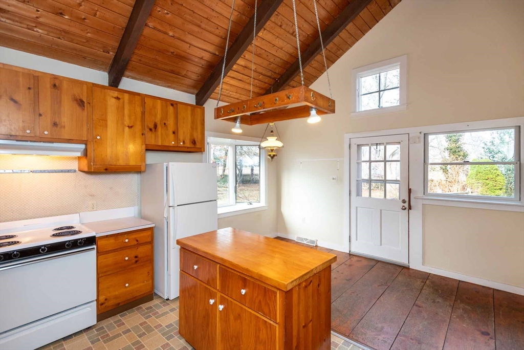 17 Chapman Lane Edgartown, MA 02539 - Photo 9 of 26 a kitchen with stainless steel appliances granite countertop a sink a stove and a wooden floors