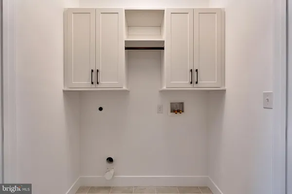 an empty room with wooden floor and ceiling fan