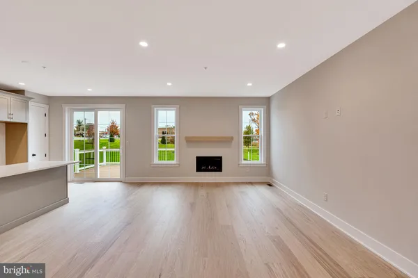 a view of empty room with a fireplace and wooden floor