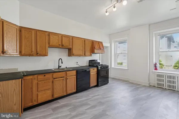 a kitchen with stainless steel appliances granite countertop a sink and cabinets