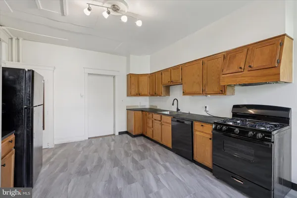 a kitchen with stainless steel appliances a stove a refrigerator and a sink