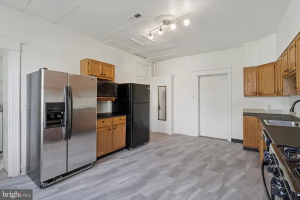 a kitchen with stainless steel appliances a refrigerator and a stove