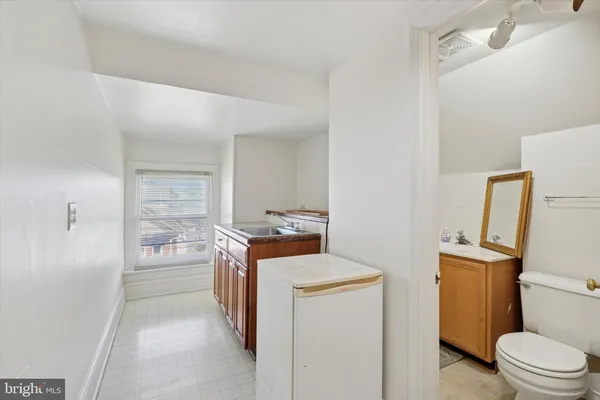 a bathroom with a sink toilet and mirror
