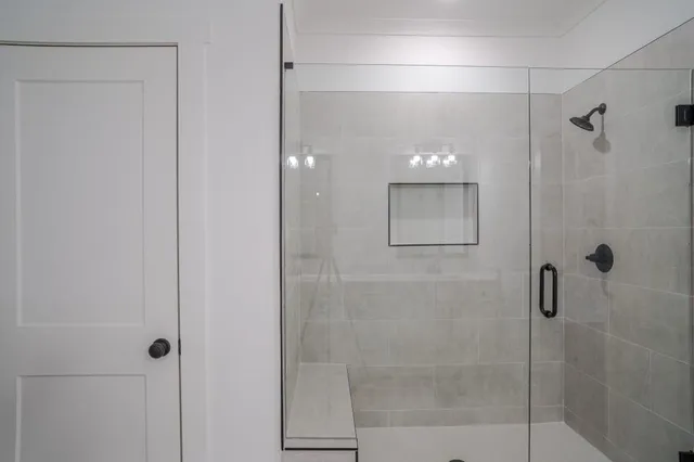 a bathroom with a shower and a mirror