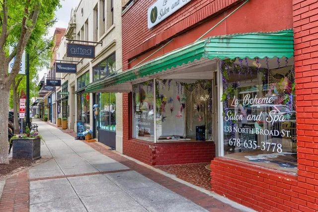 a view of path along with retail shop and buildings
