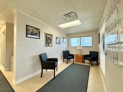 a living room with furniture and a lamp