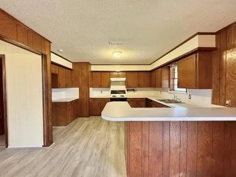 a large room with a large window and wooden floors