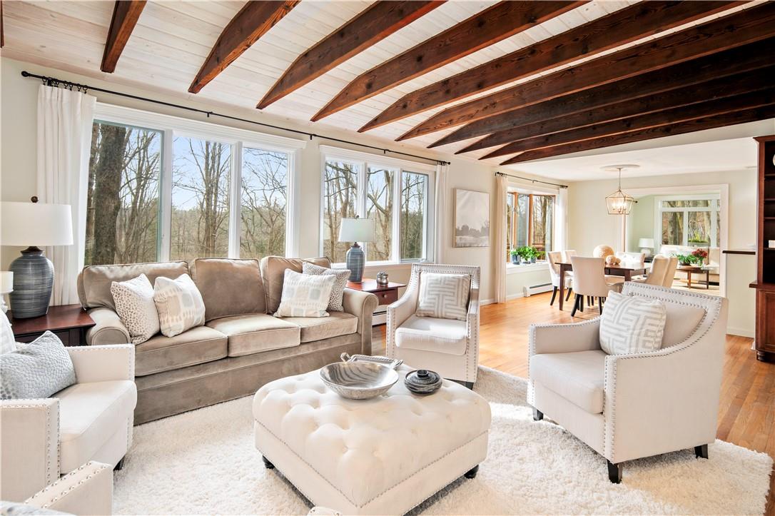 Spectacular beamed ceiling and walls of windows highlight this open floor plan - seamless flow to dining room and sunroom