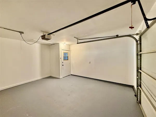 a view of a big room with wooden floor and windows